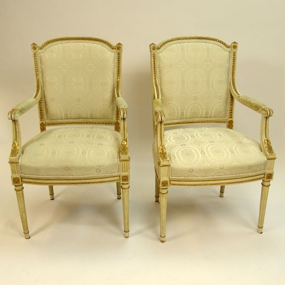 Pair of Mid 20th Century Italian Louis XVI style Carved Painted and Parcel Gilt Arm Chairs.