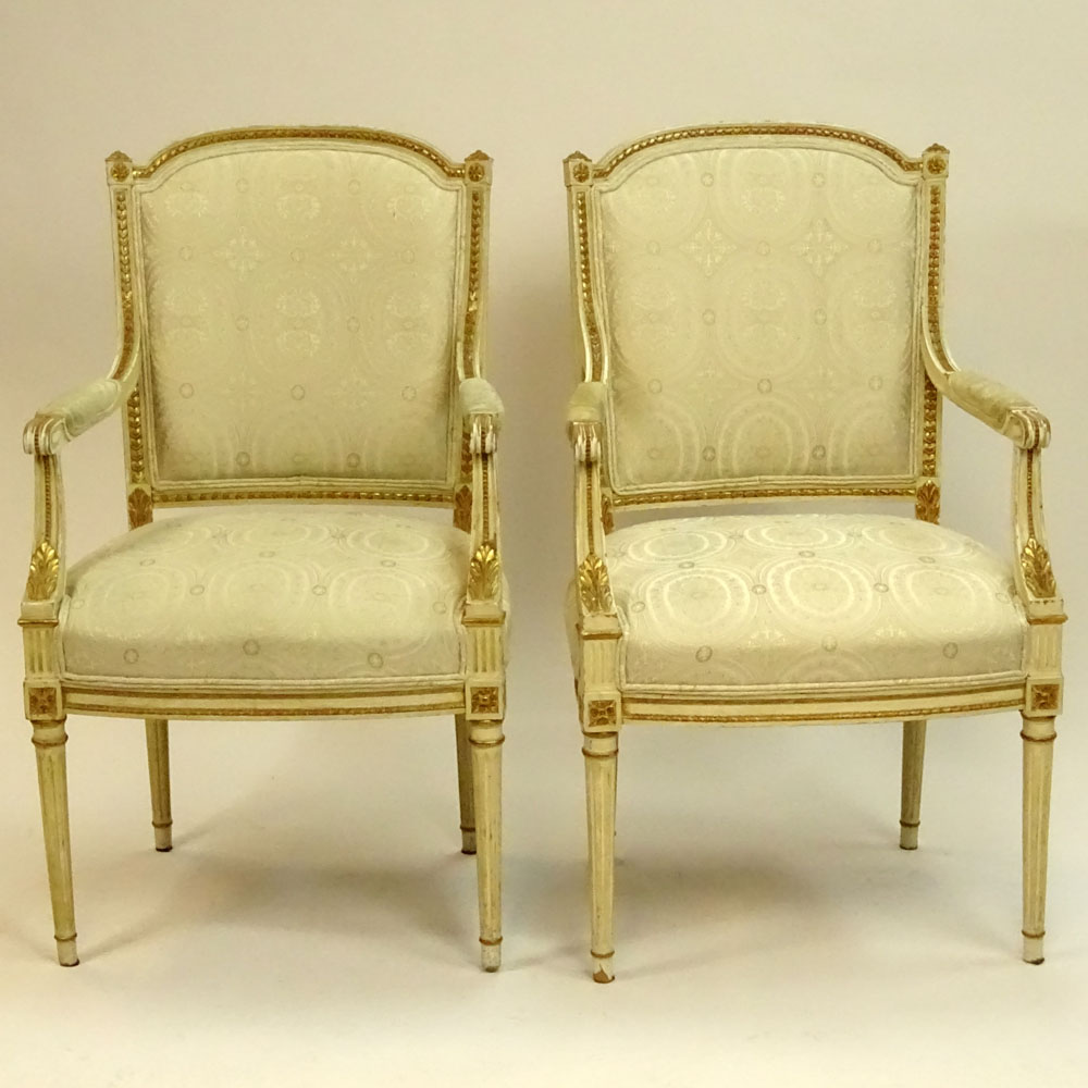 Pair of Mid 20th Century Italian Louis XVI style Carved Painted and Parcel Gilt Arm Chairs.