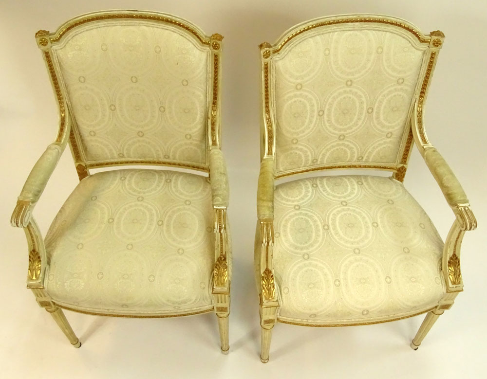Pair of Mid 20th Century Italian Louis XVI style Carved Painted and Parcel Gilt Arm Chairs.