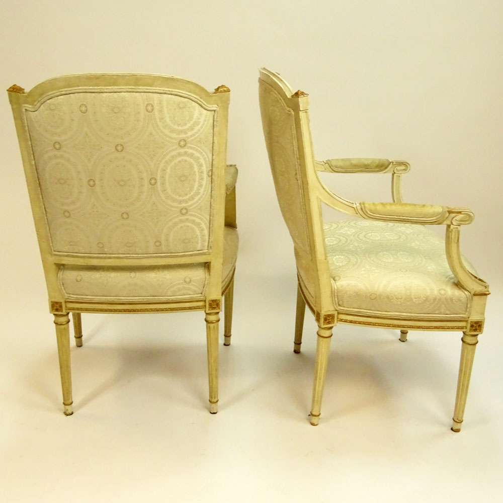 Pair of Mid 20th Century Italian Louis XVI style Carved Painted and Parcel Gilt Arm Chairs.