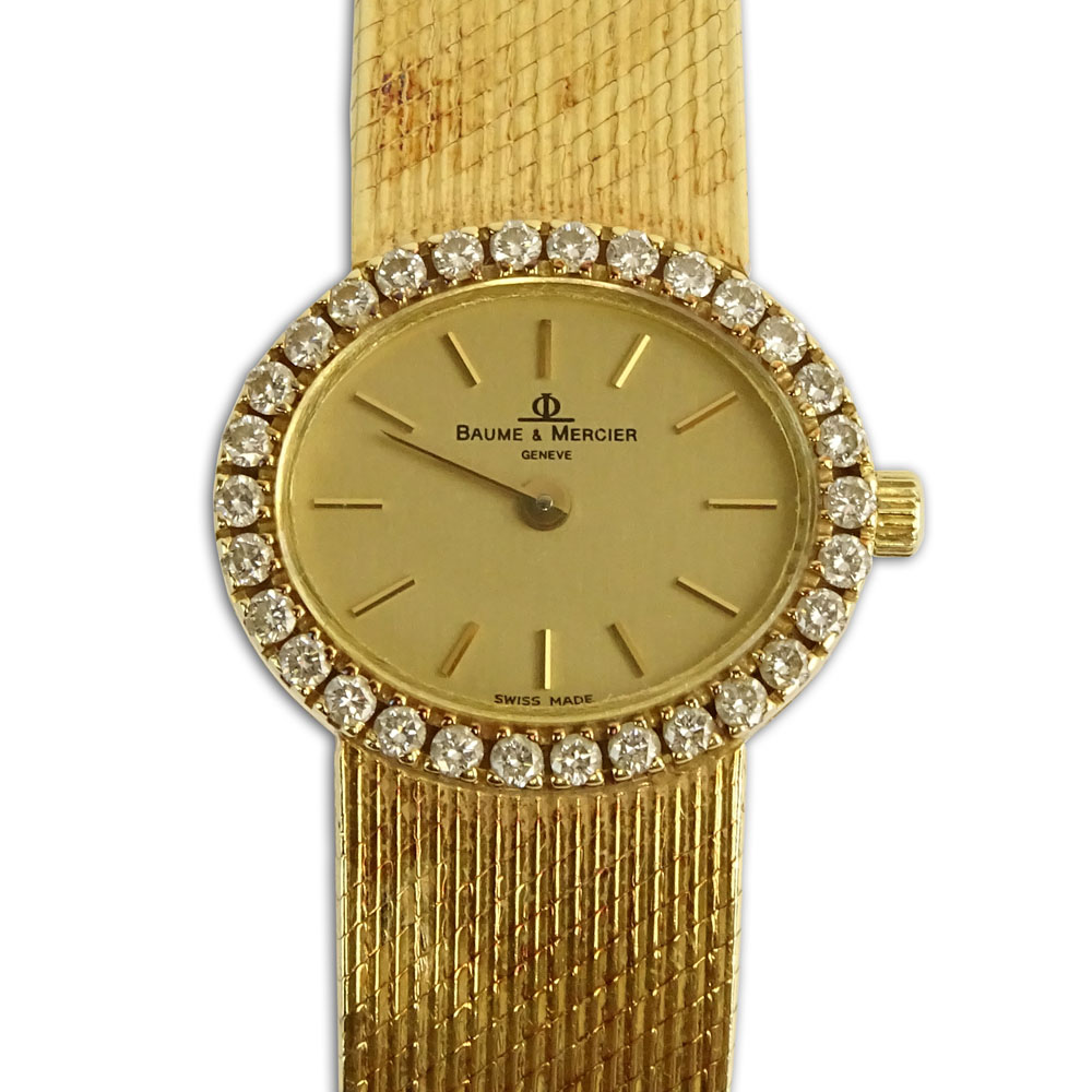 Lady's Vintage Baume & Mercier 14 Karat Yellow Gold Bracelet Watch with Diamond Bezel.