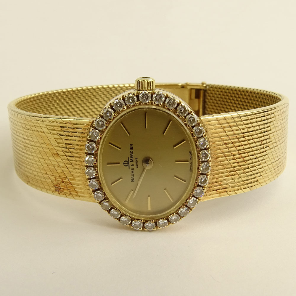 Lady's Vintage Baume & Mercier 14 Karat Yellow Gold Bracelet Watch with Diamond Bezel.