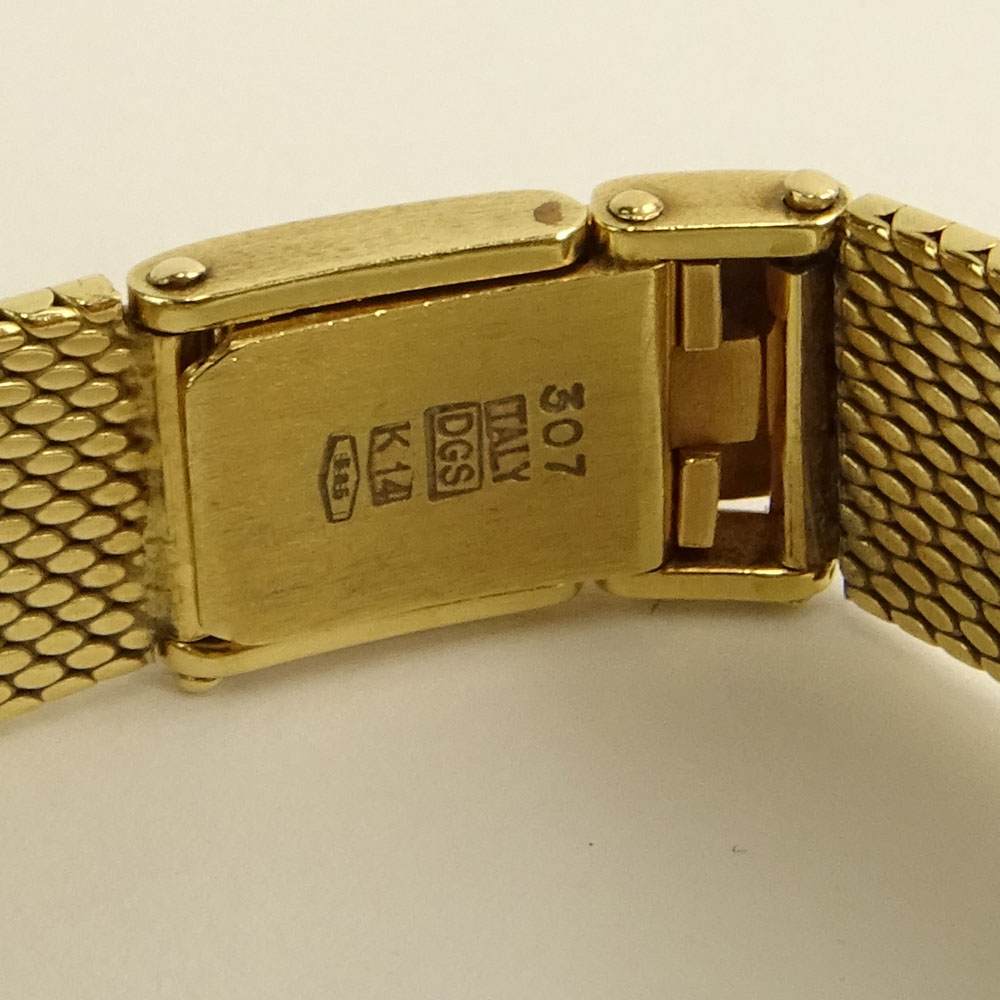 Lady's Vintage Baume & Mercier 14 Karat Yellow Gold Bracelet Watch with Diamond Bezel.