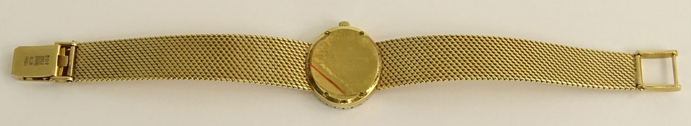 Lady's Vintage Baume & Mercier 14 Karat Yellow Gold Bracelet Watch with Diamond Bezel.