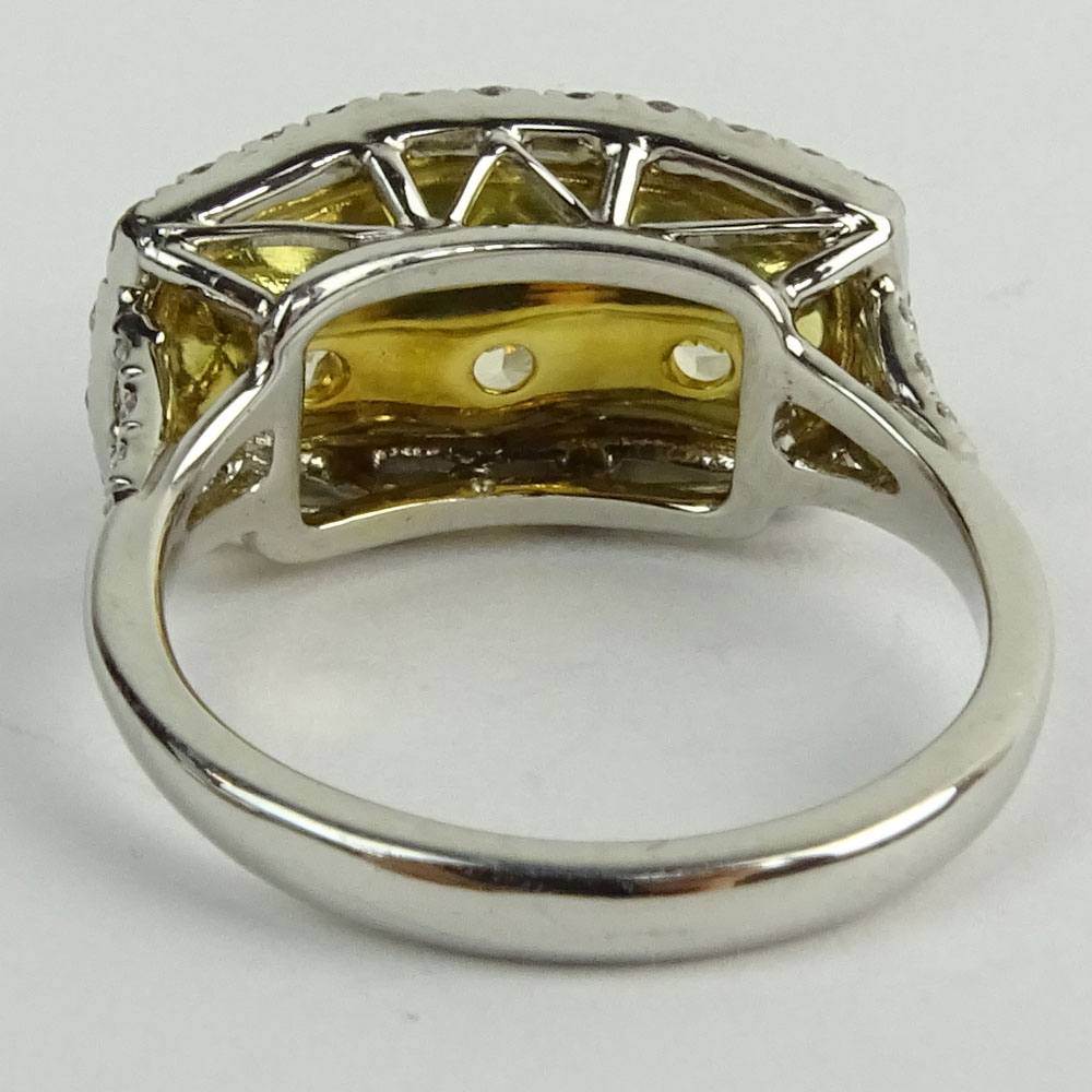 Approx. 3.0 Carat Cushion Cut Fancy Yellow Diamond, Platinum and 18 Karat Yellow Gold Three Stone Ring.