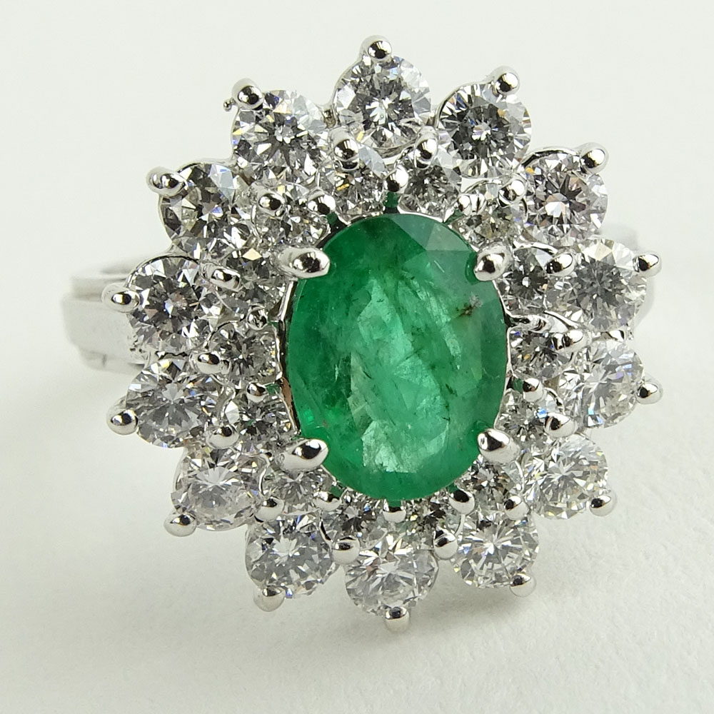 Lady's 1.60 Carat Oval Cut Emerald, 1.45 Carat Round Cut Diamond and 14 Karat White Gold Ring. 