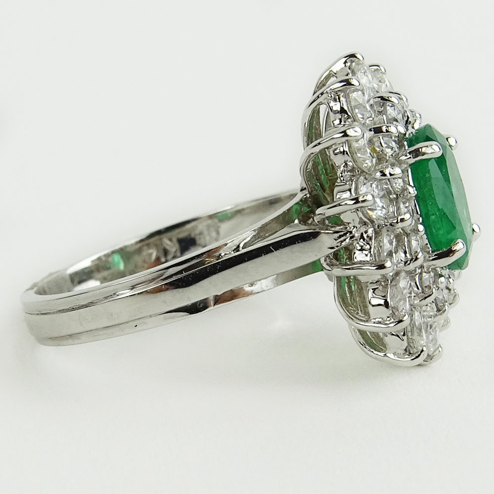 Lady's 1.60 Carat Oval Cut Emerald, 1.45 Carat Round Cut Diamond and 14 Karat White Gold Ring. 