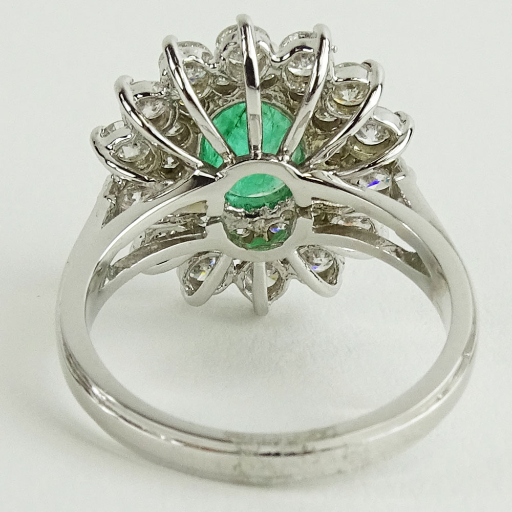 Lady's 1.60 Carat Oval Cut Emerald, 1.45 Carat Round Cut Diamond and 14 Karat White Gold Ring. 