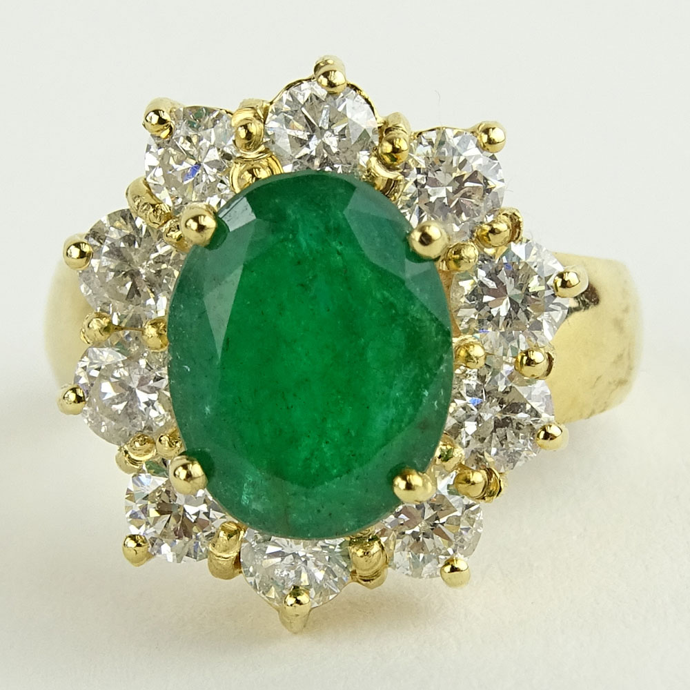 Lady's 4.00 Carat Oval Cut Emerald, 1.80 Carat Round Cut Diamond and 14 Karat Yellow Gold Ring. 