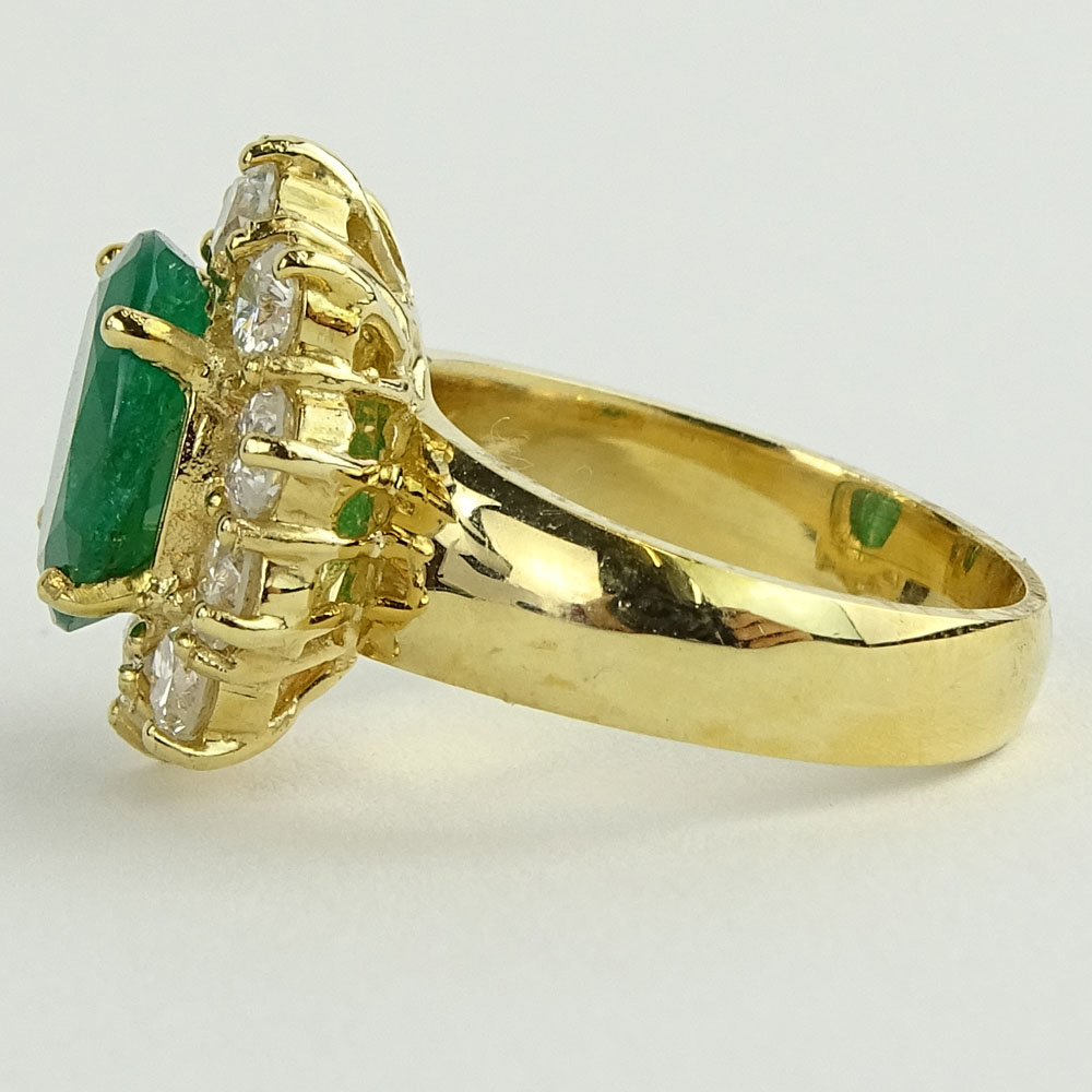 Lady's 4.00 Carat Oval Cut Emerald, 1.80 Carat Round Cut Diamond and 14 Karat Yellow Gold Ring. 