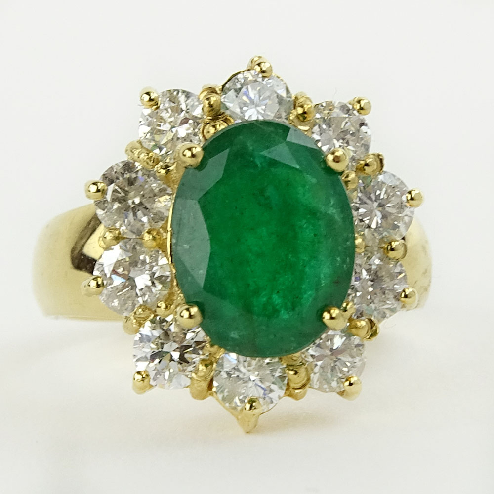 Lady's 4.00 Carat Oval Cut Emerald, 1.80 Carat Round Cut Diamond and 14 Karat Yellow Gold Ring. 