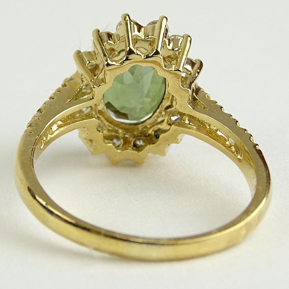 2.35 Carat Oval Cut Green Tourmaline, 1.10 Carat Round Cut Diamond and 14 Karat Yellow Gold Ring.