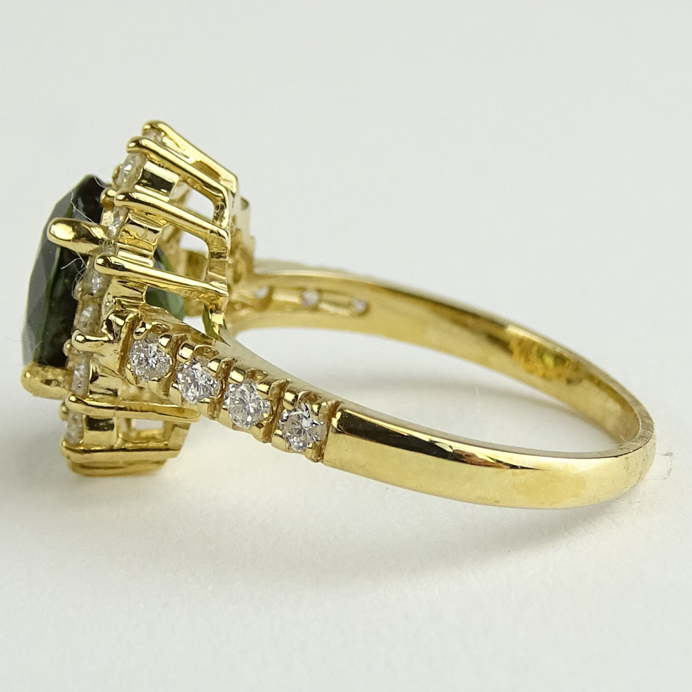 2.35 Carat Oval Cut Green Tourmaline, 1.10 Carat Round Cut Diamond and 14 Karat Yellow Gold Ring.