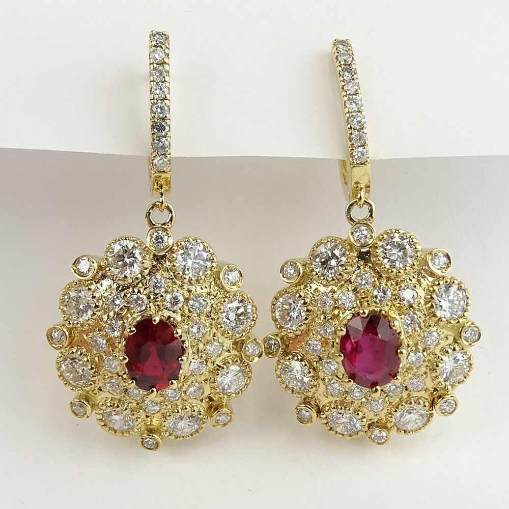 2.50 Carat Oval Cut Ruby, 7.00 Carat Round Cut Diamond and 14 Karat Yellow Gold Earrings.