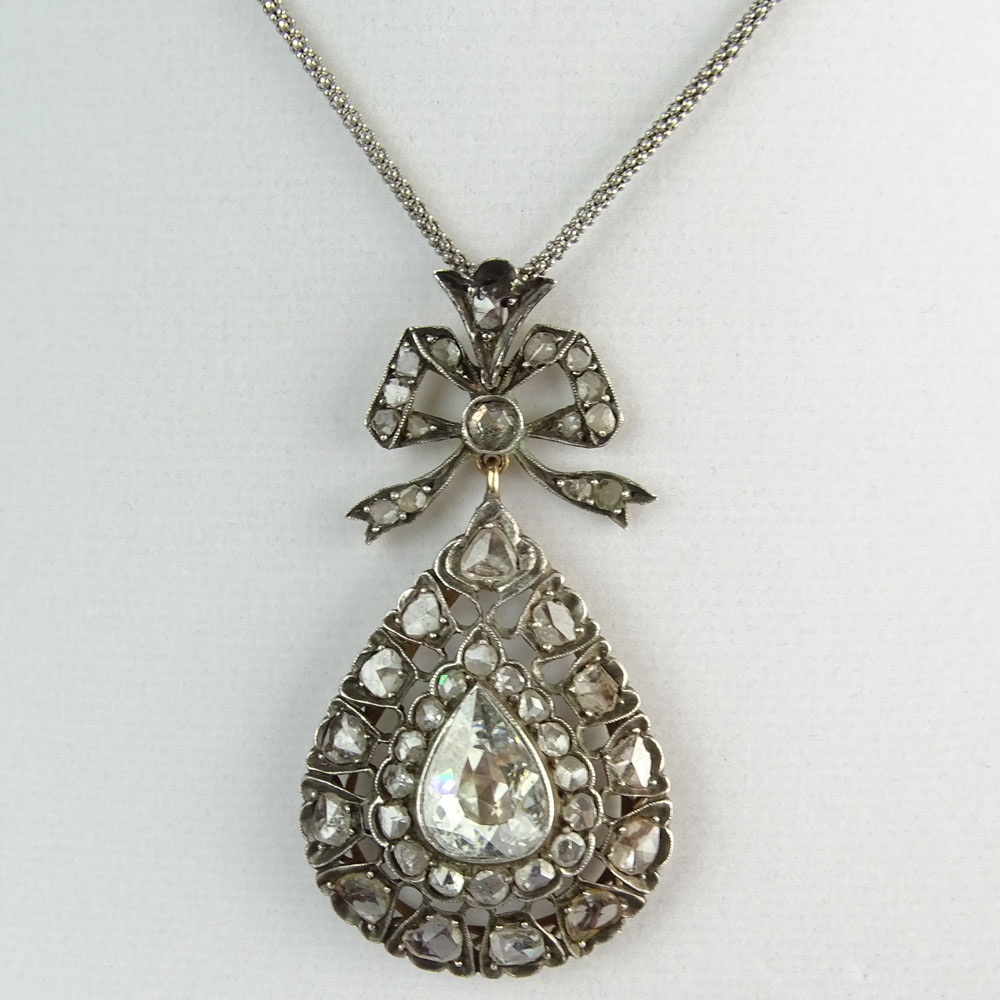 Antique Diamond, Gold and Silver Pendant Necklace set in the Center with a Pear Shape Diamond and accented with Rose Cut Diamonds. 