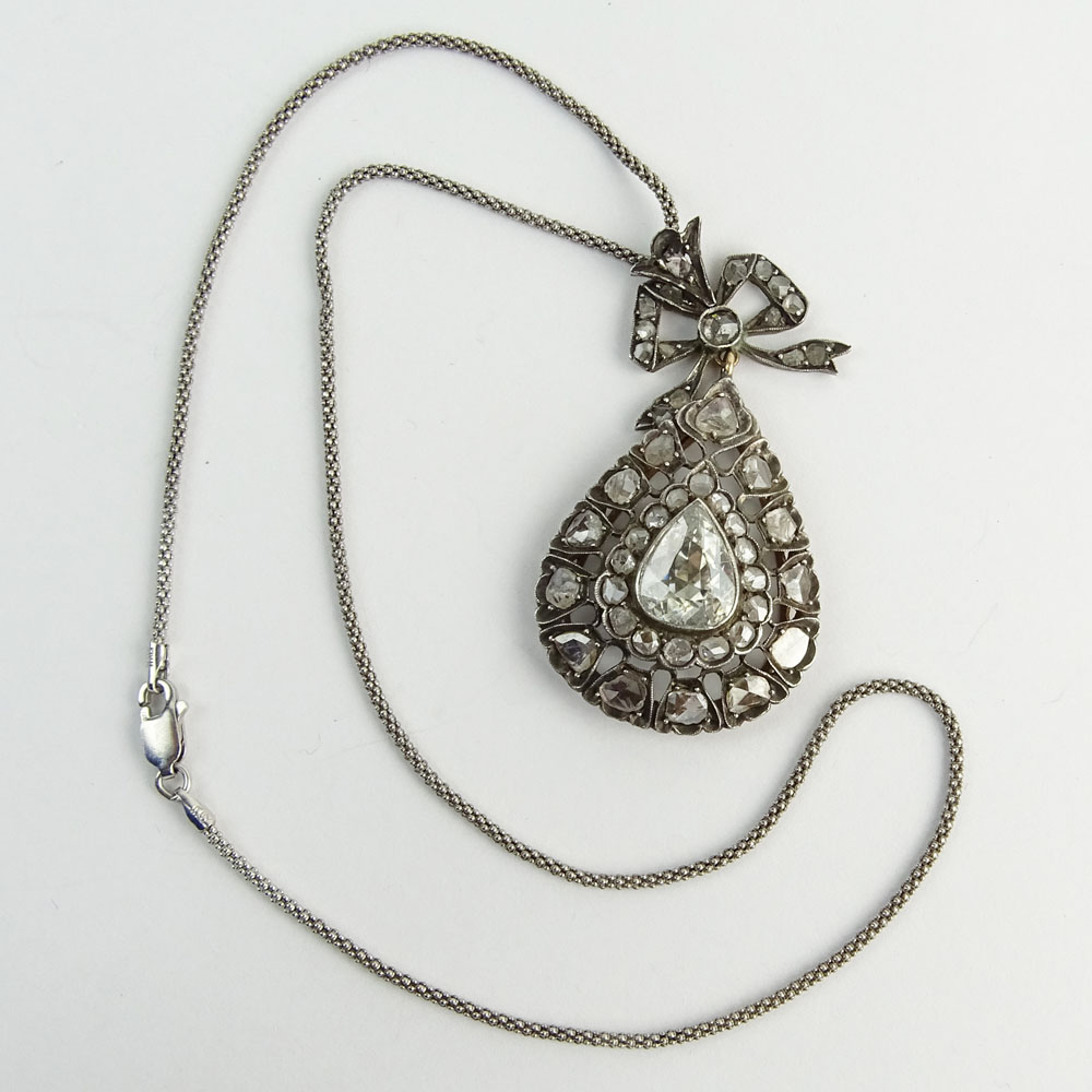 Antique Diamond, Gold and Silver Pendant Necklace set in the Center with a Pear Shape Diamond and accented with Rose Cut Diamonds. 