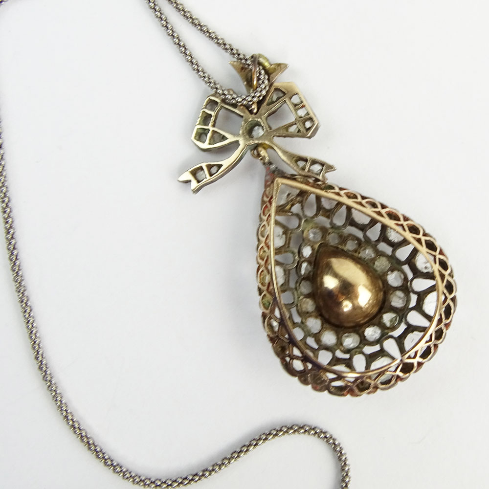 Antique Diamond, Gold and Silver Pendant Necklace set in the Center with a Pear Shape Diamond and accented with Rose Cut Diamonds. 