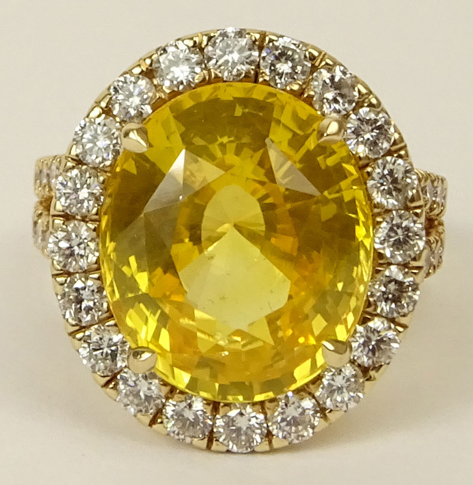 GIA Certified 12.65 Carat Oval Cut Yellow Sapphire and 18 Karat Yellow Gold Ring accented throughout with Round Brilliant Cut Diamonds