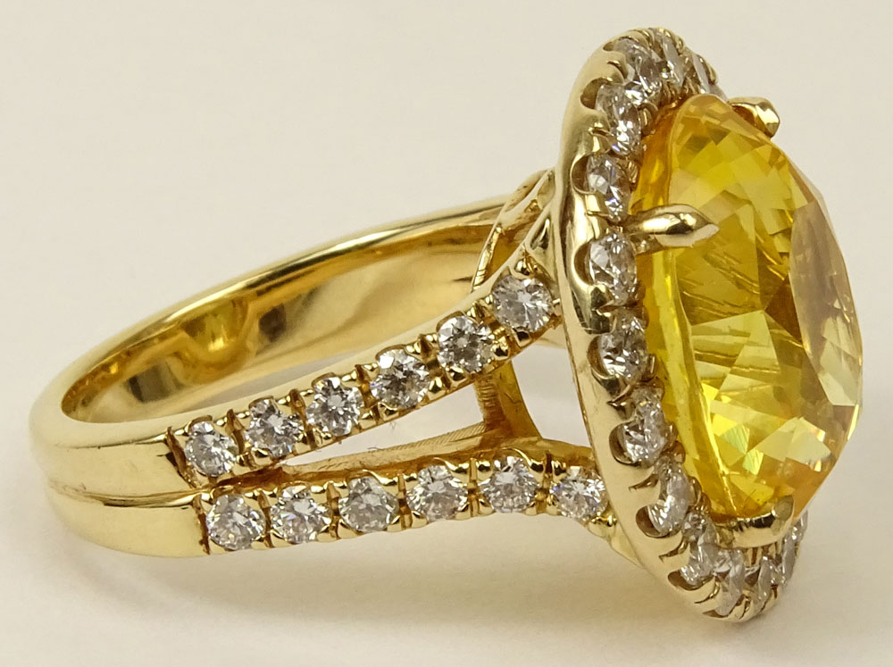 GIA Certified 12.65 Carat Oval Cut Yellow Sapphire and 18 Karat Yellow Gold Ring accented throughout with Round Brilliant Cut Diamonds