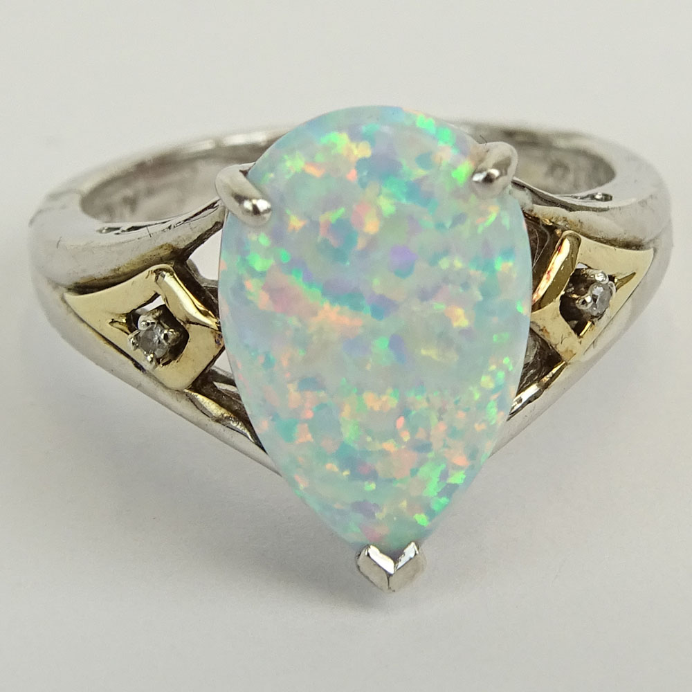 Lady's Vintage Pear Shape Australian White Opal Ring Set in Sterling Silver Accented with 14 Karat Yellow Gold and small round cut Diamonds.