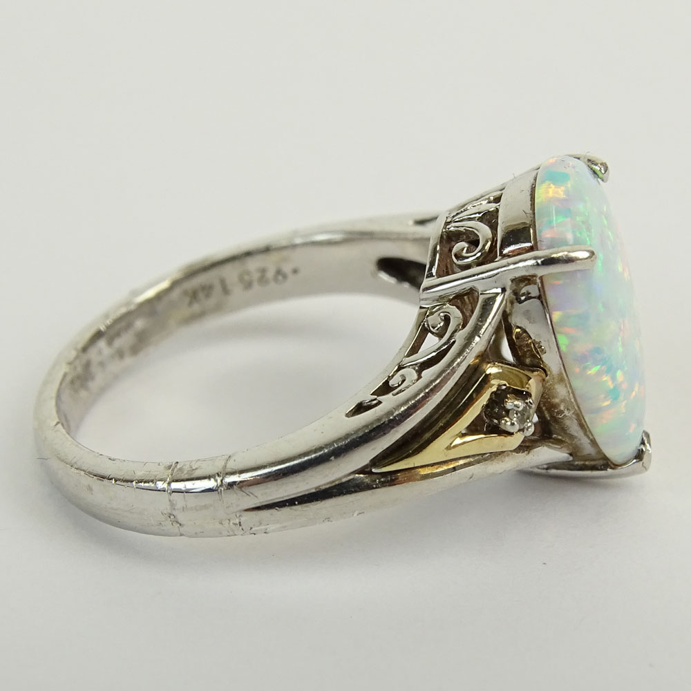 Lady's Vintage Pear Shape Australian White Opal Ring Set in Sterling Silver Accented with 14 Karat Yellow Gold and small round cut Diamonds.