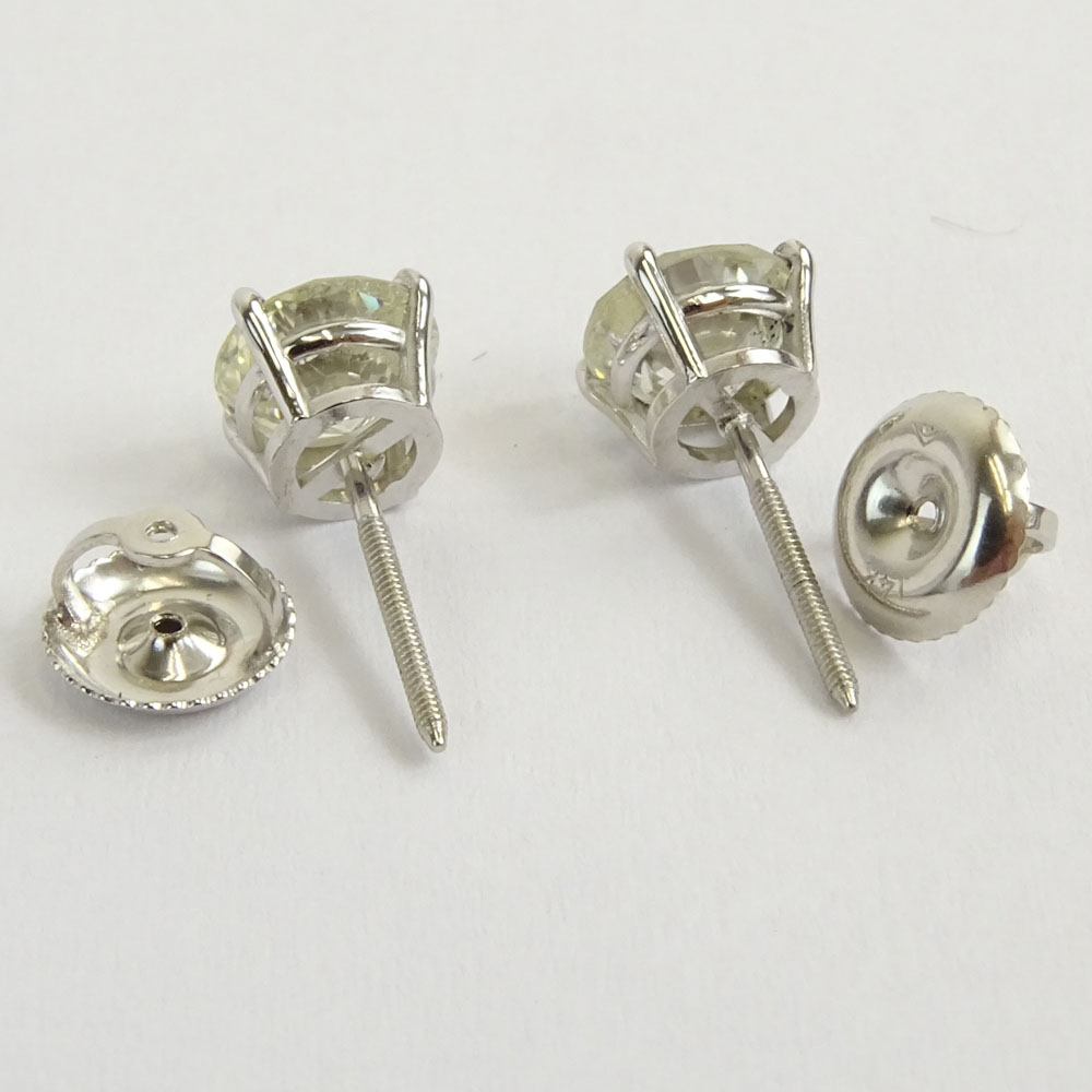 AIG Certified 1.57 Carat, total weight, Round Brilliant Cut Diamond and 14 Karat White Gold Earstuds.