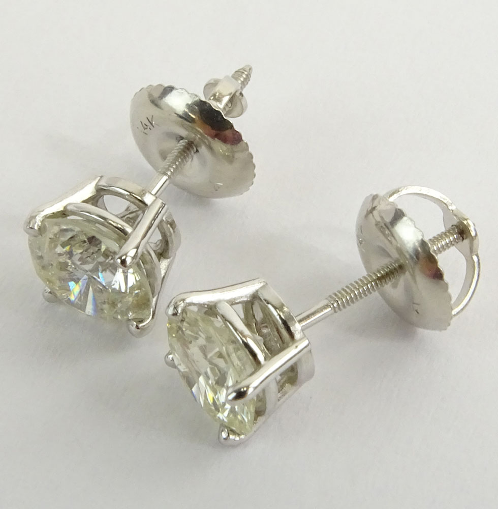 AIG Certified 1.57 Carat, total weight, Round Brilliant Cut Diamond and 14 Karat White Gold Earstuds.