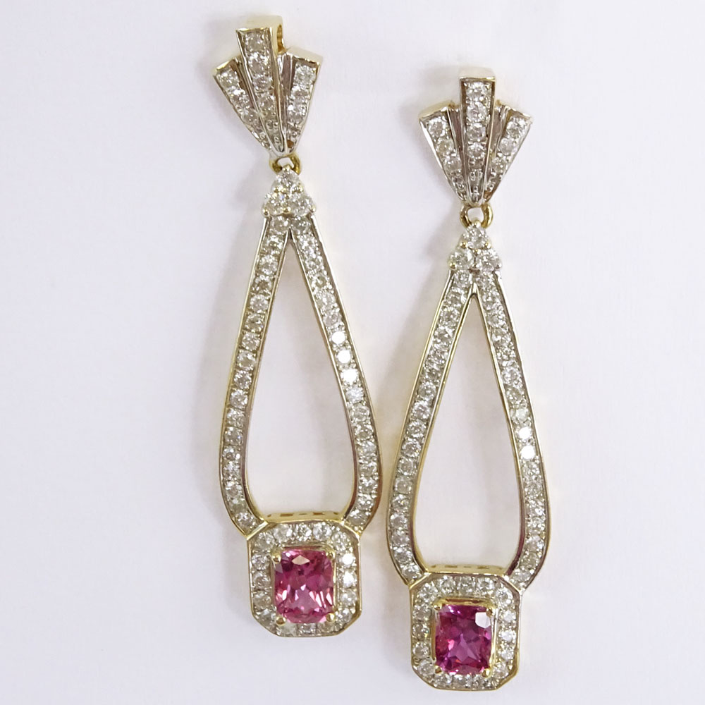 AIG Certified 1.46 Carat, total weight, Rectangular Cushion Cut Pink Sapphire, 1.42 Carat Round Brilliant Cut Diamond and 14 Karat Yellow Gold Pendant Earrings.