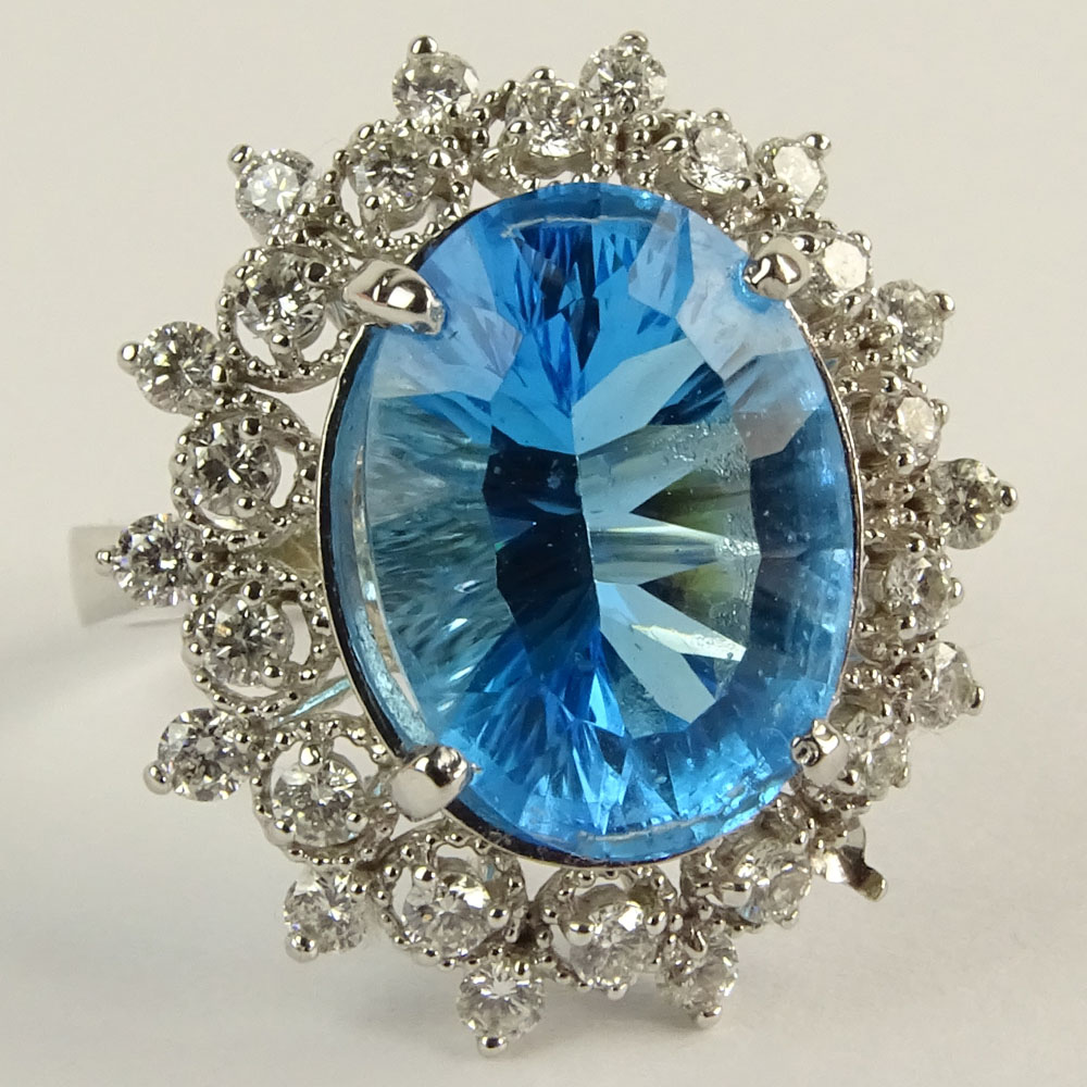 Lady's Oval Cut London Topaz, Round Brilliant Cut Diamond and 14 Karat White Gold Ring.