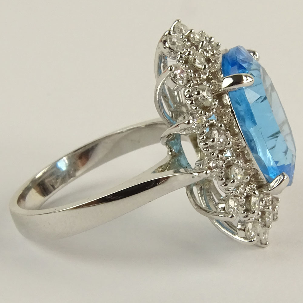 Lady's Oval Cut London Topaz, Round Brilliant Cut Diamond and 14 Karat White Gold Ring.