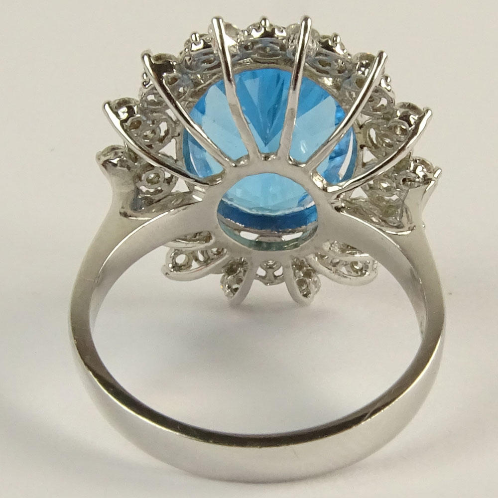 Lady's Oval Cut London Topaz, Round Brilliant Cut Diamond and 14 Karat White Gold Ring.