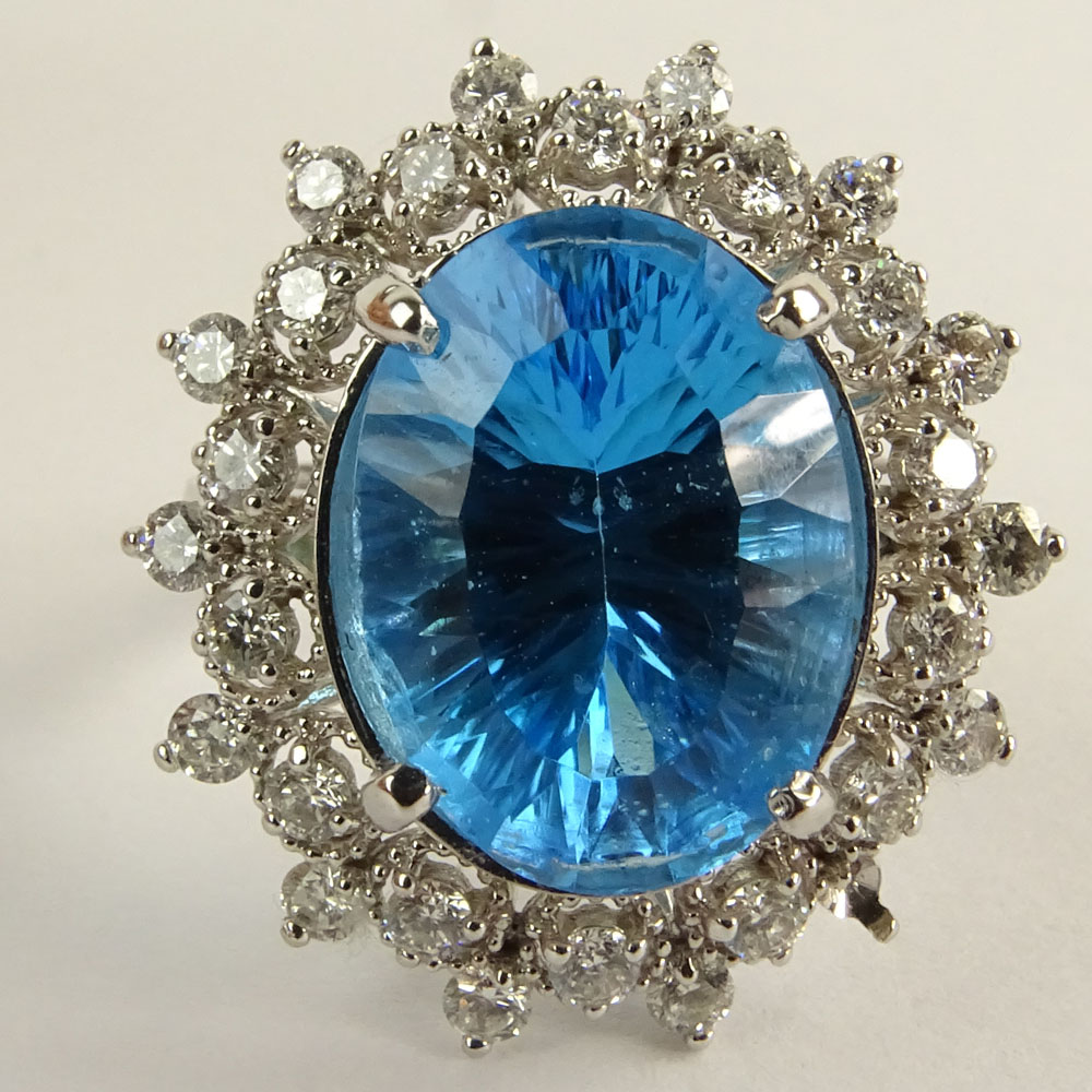 Lady's Oval Cut London Topaz, Round Brilliant Cut Diamond and 14 Karat White Gold Ring.