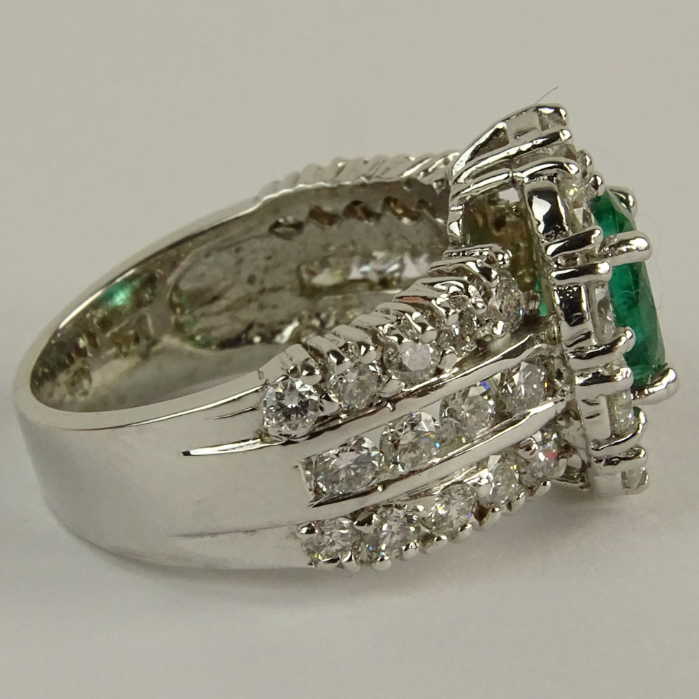 Lady's Oval Cut Emerald,  Round Brilliant Cut Diamond and 14 Karat White Gold Ring. 