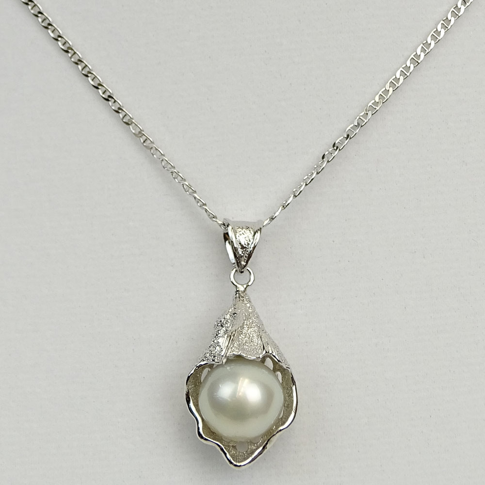 Lady's White Pearl and Sterling Silver Pendant Necklace. Pearl measures 13.0mm.