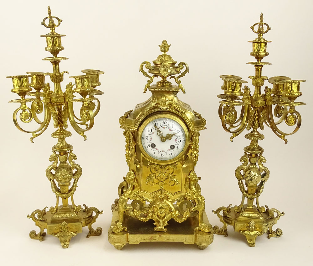 Antique Three (3) piece French ormolu bronze clock garniture set. Figural motif, hand painted dial. 