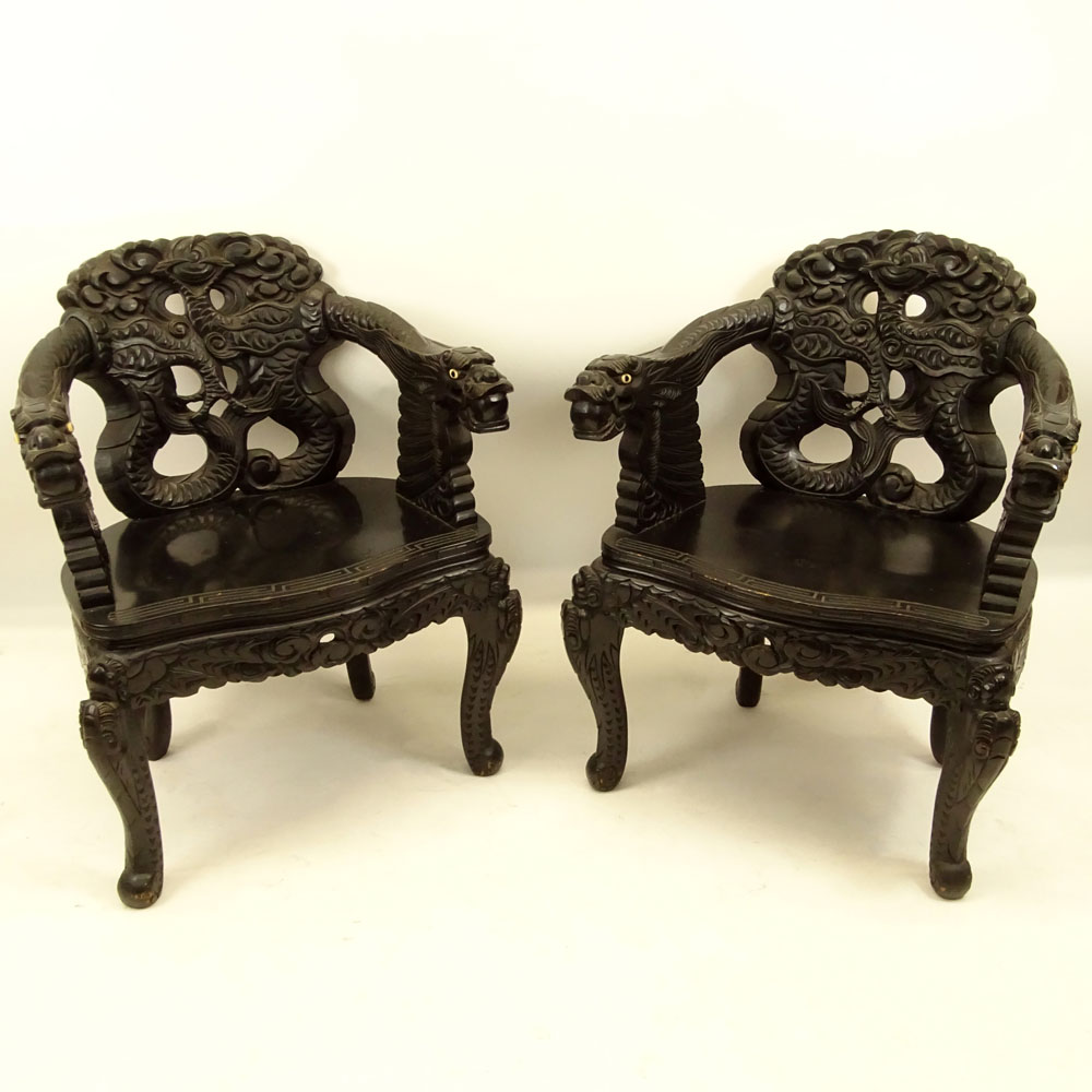 Pair of 20th Century Chinese Carved Wood Dragon Arm Chairs. Inset eyes.