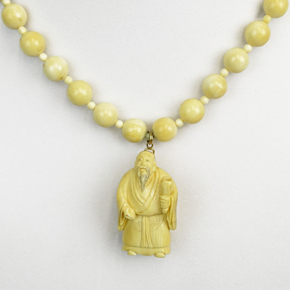 Japanese Ivory Bead Necklace with Carved Ivory Figural Pendant.