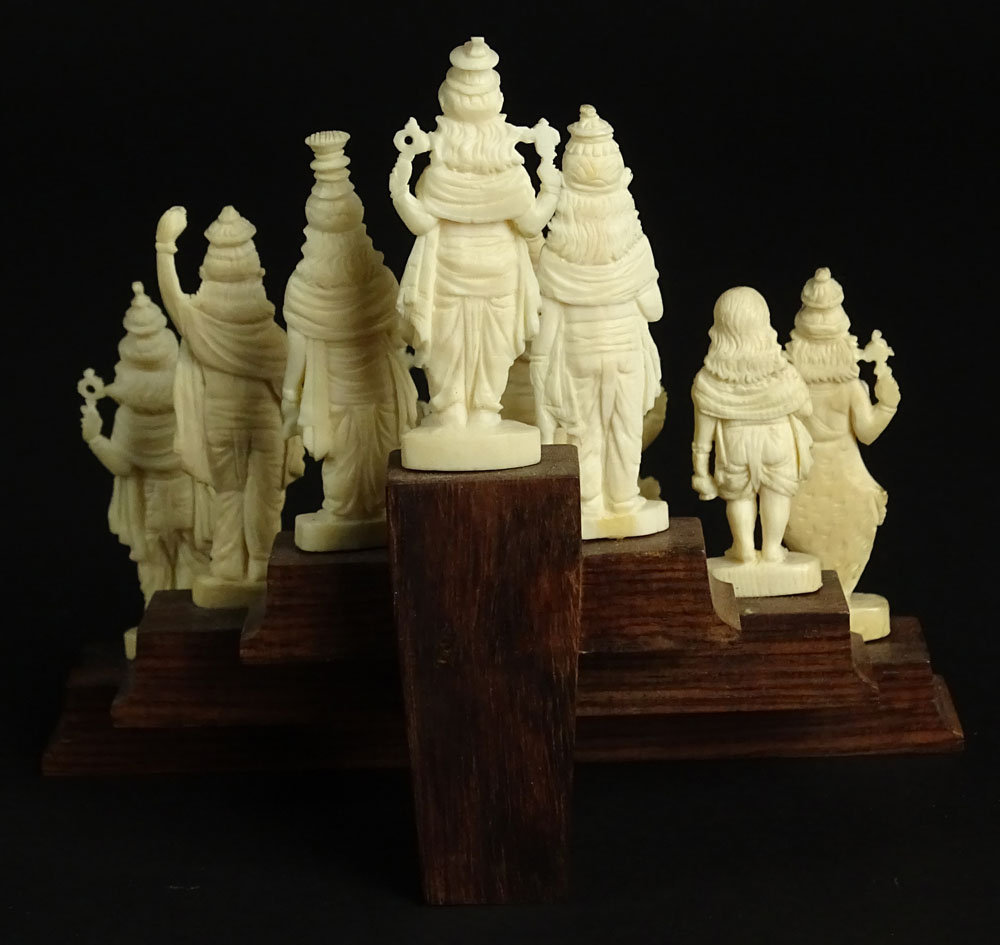 Ten (10) Indian Carved Ivory Deity Figures on Stepped Wood Base.