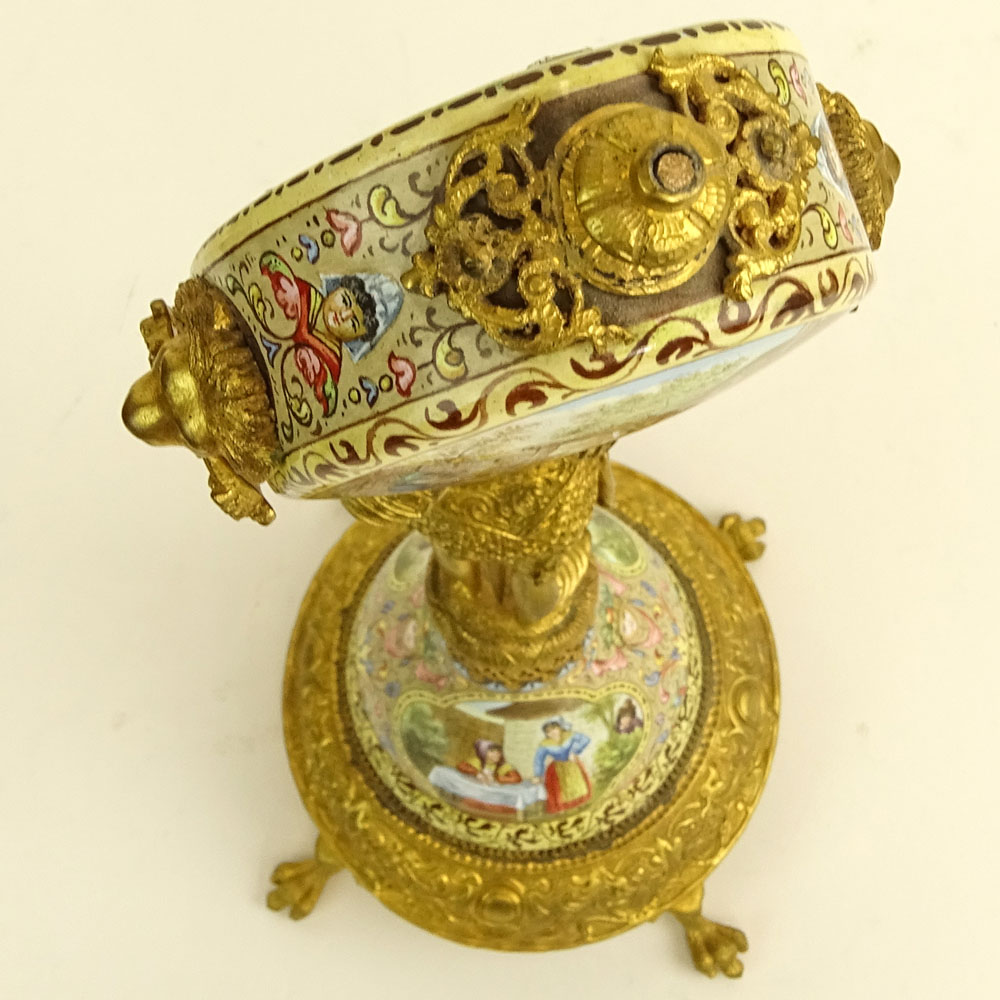 Early 20th Century Vienna Enamel and Gilt Metal Watch Holder. Unsigned. Losses/Damages to finial and to watch holder. Please examine this lot carefully before bidding. Measures 13-1/2" H (without bird finial), 4" W at base. Shipping $48.00 (estimate $500-