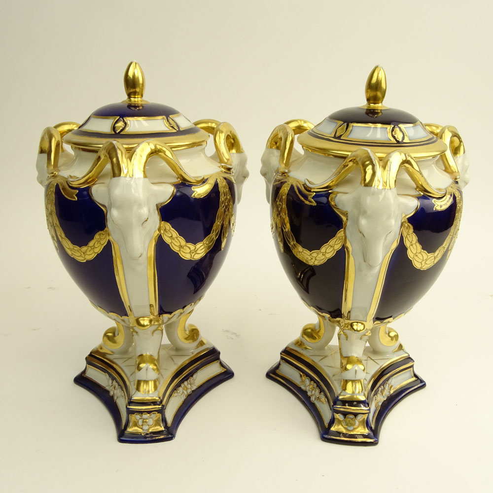 Pair Royal Dux Porcelain Cobalt and Parcel Gilt Covered Urns. Ram's head handles.