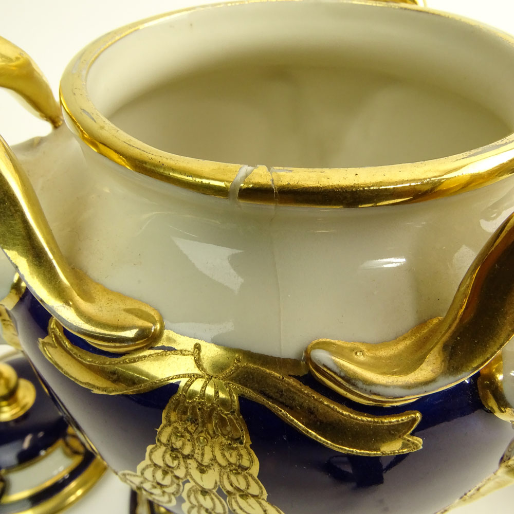 Pair Royal Dux Porcelain Cobalt and Parcel Gilt Covered Urns. Ram's head handles.