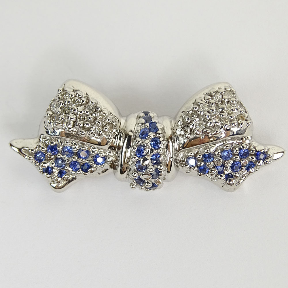 Levian Approx. .30 Carat Round Brilliant Cut Diamond, 2.05 Carat Round Cut Sapphire and 14 Karat White Gold Bow Pin.