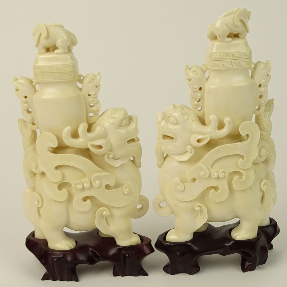 Pair of Vintage well carved Ivory Foo Lion Urns on Hardwood Stands.