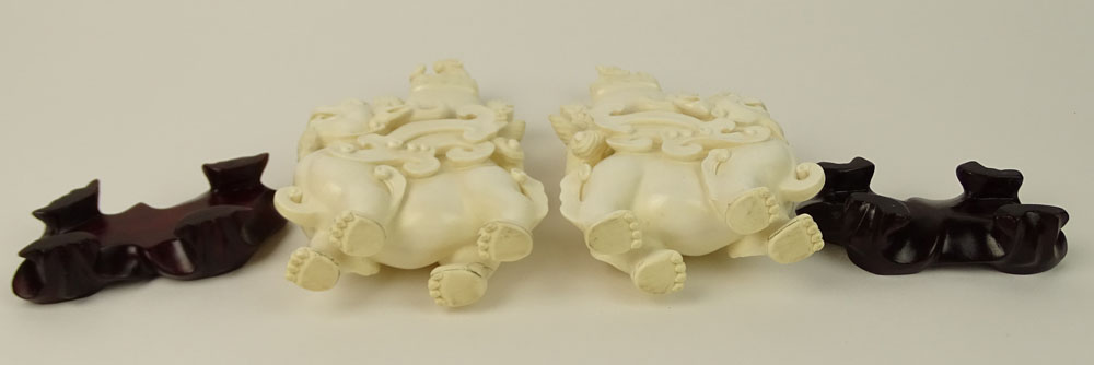 Pair of Vintage well carved Ivory Foo Lion Urns on Hardwood Stands.