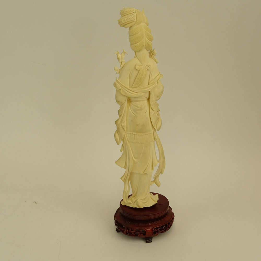 Mid 20th Century Chinese Carved Ivory Guanyin Figure on Carved Wood Base.