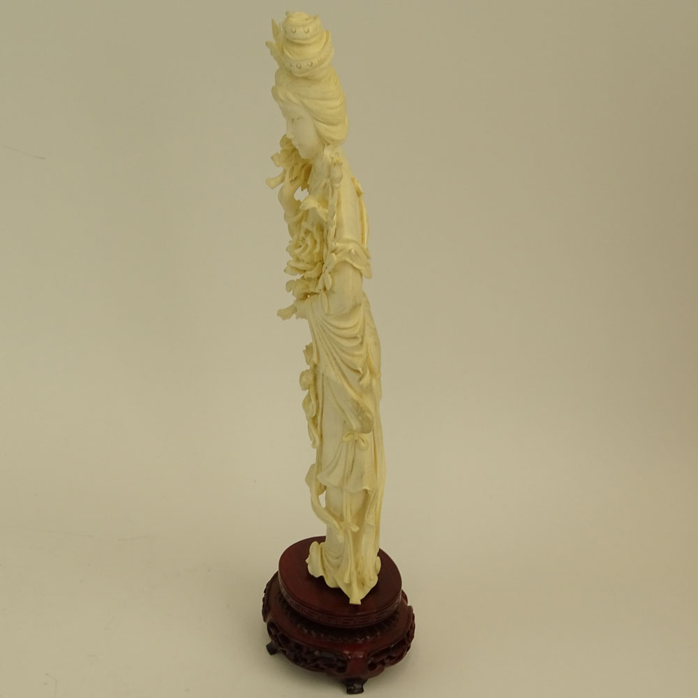 Mid 20th Century Chinese Carved Ivory Guanyin Figure on Carved Wood Base.