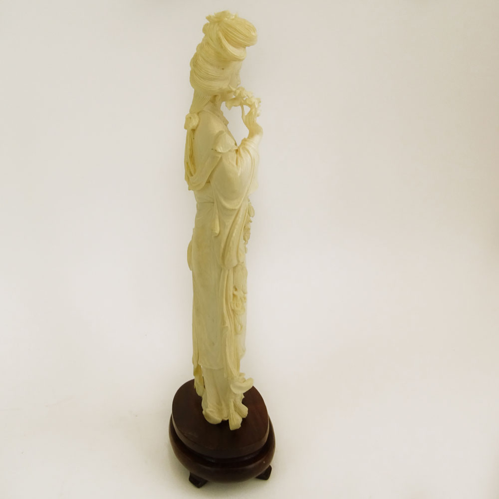 Mid 20th Century Chinese Carved Ivory Guanyin Figure on Carved Wood Base.