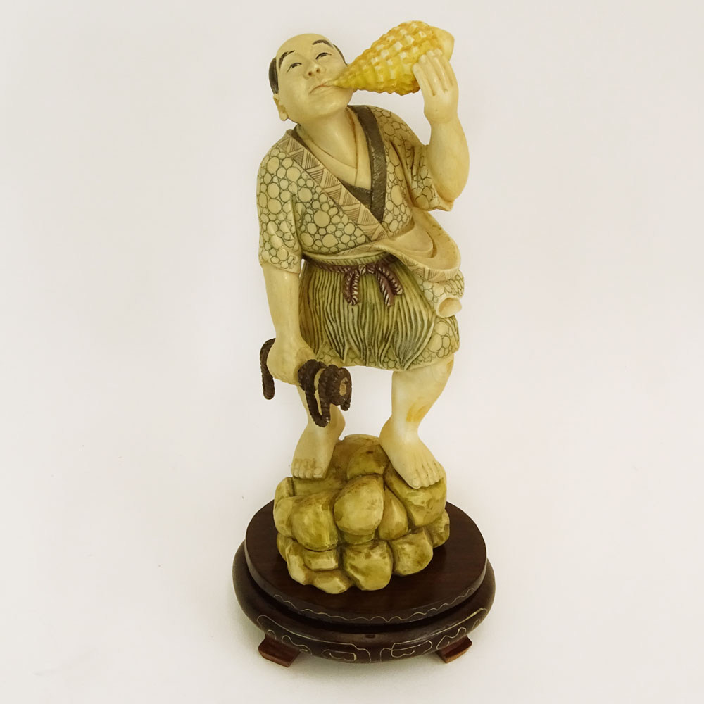 Mid 20th Century Japanese Carved Ivory with wood base, Man with Sea Shell. 