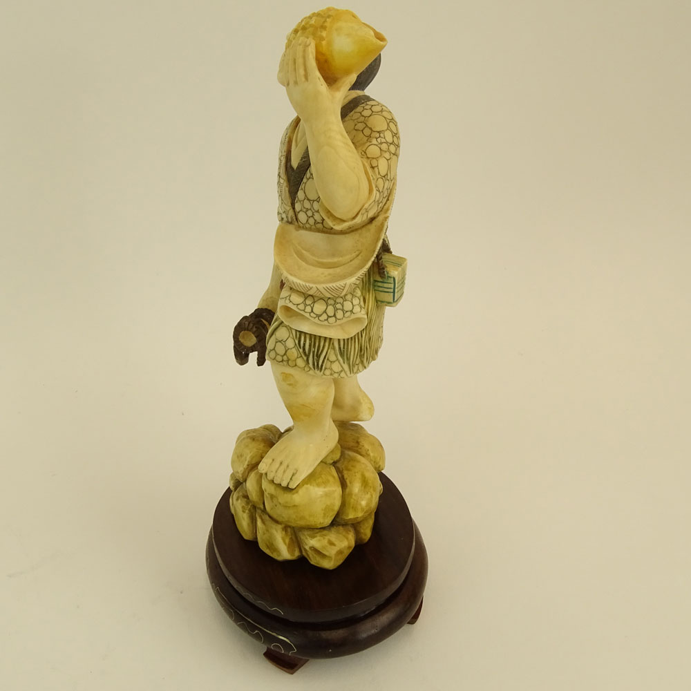 Mid 20th Century Japanese Carved Ivory with wood base, Man with Sea Shell. 