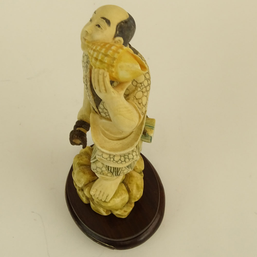 Mid 20th Century Japanese Carved Ivory with wood base, Man with Sea Shell. 